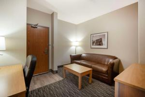 a hotel room with a couch and a table at Best Western Grande Prairie in Grande Prairie