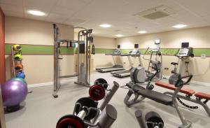 a gym with several treadmills and cardio machines at Hampton by Hilton Birmingham Broad Street in Birmingham