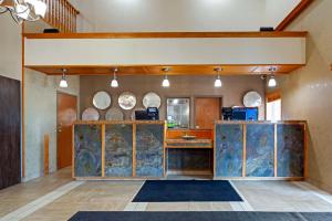 a large kitchen with a counter in a room at Best Western Grande Prairie in Grande Prairie