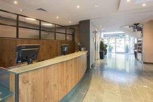 an office lobby with a reception counter and a hallway at Hilton Garden Inn Bristol City Centre in Bristol