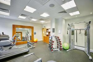 a gym with treadmills and machines in a room at Hilton Garden Inn Bristol City Centre in Bristol