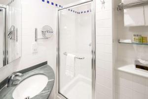 a bathroom with a shower with a sink and a toilet at Hilton Garden Inn Bristol City Centre in Bristol