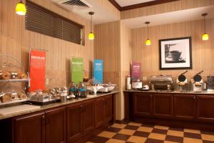 a restaurant with a buffet line with food at Hampton Inn Tomah in Tomah