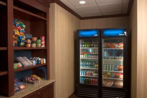 a refrigerator in a room with food and drinks at Hampton Inn Tomah in Tomah