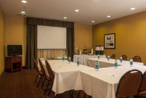 a conference room with tables and chairs with water bottles on them at Hampton Inn Tomah in Tomah
