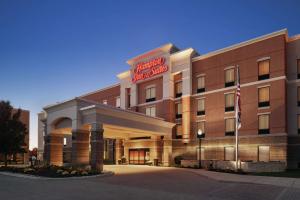 a hotel building with a sign on the front of it at Hampton Inn & Suites Mishawaka/South Bend at Heritage Square in South Bend