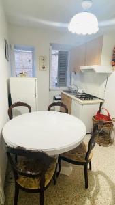 a kitchen with a white table and a white refrigerator at Domi B & B in Macerata