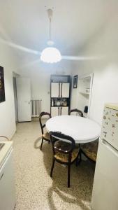 a kitchen with a table and chairs and a refrigerator at Domi B & B in Macerata