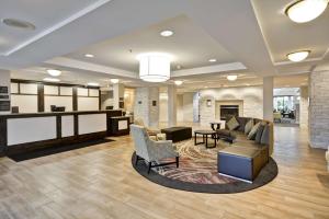 a lobby with a waiting area with couches and chairs at Homewood Suites Dulles-International Airport in Herndon