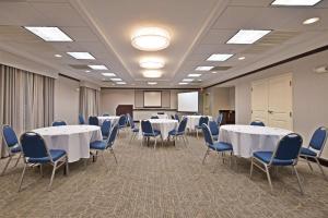 a conference room with white tables and blue chairs at Hampton Inn Gainesville-Haymarket in Gainesville +36 photos