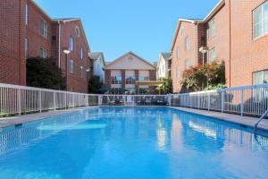 a large swimming pool in a courtyard with buildings at Homewood Suites Nashville Airport in Nashville