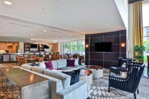 a living room with a couch and a table at DoubleTree by Hilton Baton Rouge in Baton Rouge