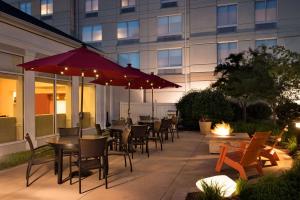 a patio with tables and chairs and a building at Hilton Garden Inn Wilkes-Barre in Wilkes-Barre