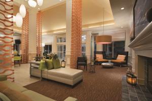 a living room with a couch and a fireplace at Hilton Garden Inn Wilkes-Barre in Wilkes-Barre