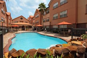 a large swimming pool in front of a building at Homewood Suites by Hilton Houston-Woodlands-Shenandoah in The Woodlands