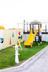 a playground with two slides and a play structure at KABACEIRA VILLAGE in Atalaia