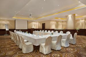 a large meeting room with a large white table and chairs at DoubleTree by Hilton Dhahran in Al Khobar