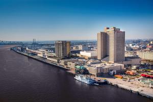 an aerial view of a city with a river and buildings at Hilton New Orleans Riverside in New Orleans