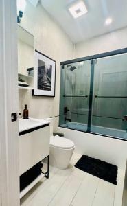 a bathroom with a toilet and a glass shower at 2 Bedroom Apartment, Close to NYC & Downtown JC! in Jersey City