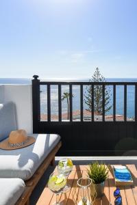 a couch on a balcony with a view of the ocean at Los Canarios 630 by VillaGranCanaria in Patalavaca