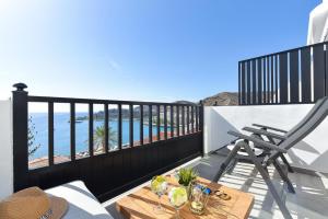 a balcony with a table and a view of the ocean at Los Canarios 630 by VillaGranCanaria in Patalavaca