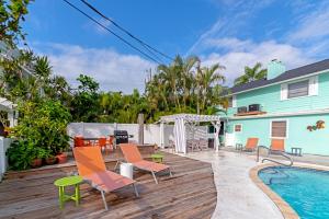 a deck with chairs and a swimming pool at Siesta-Retreats - Key West Unit in Siesta Key