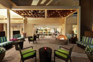 a lobby of a hotel with chairs and a fireplace at Home2 Suites By Hilton Savannah Airport in Savannah