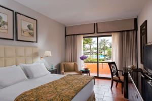 a hotel room with a bed and a balcony at Hilton Cairo Heliopolis Hotel in Cairo