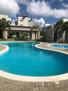 a large blue swimming pool in front of a building at Insta-worthy luxurious 3-BR Apt W/ Gazebo in Santiago de los Caballeros
