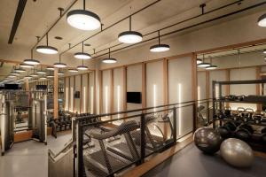 una habitación con un gimnasio con sillas y luces en Hart Shoreditch Hotel London, Curio Collection by Hilton en Londres