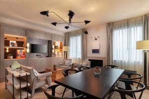 a living room with a table and chairs and a dining room at Hart Shoreditch Hotel London, Curio Collection by Hilton in London