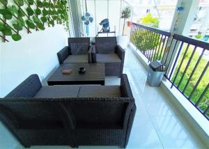 a porch with a couch and a table on a balcony at Niko's Apartment - Beautiful Sea Apartment ! in Perea