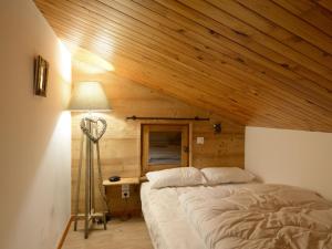 a bedroom with a bed in a wooden room at Appartement rénové proche station avec balcons et vue, 3 ch, 10 pers - FR-1-181-2457 in La Plagne Tarentaise