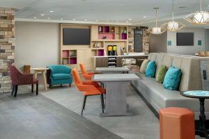a waiting room with a couch and chairs at Home2 Suites By Hilton Columbus Polaris in Columbus