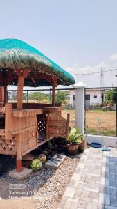 a gazebo with a green umbrella and some plants at Budget room with split type air-condition in San Fernando