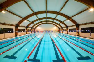 an empty swimming pool with blue water at Domi B & B in Macerata