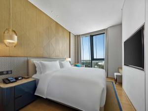 Postel nebo postele na pokoji v ubytování Hilton Hainan Ocean Flower Island