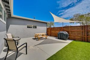 a patio with a picnic table and chairs and a fence at Sleek San Diego Vacation Rental with Private Patio! in San Diego