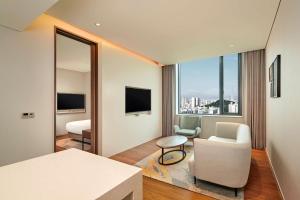 a hotel room with a view of the city at Hilton Garden Inn Seoul Gangnam in Seoul