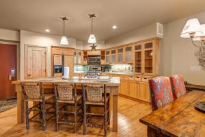 a kitchen with wooden cabinets and a wooden table and chairs at Lodges at Deer Valley 2218 and 2220 in Park City