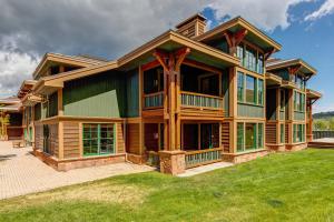 a large wooden house with a lawn in front of it at Lodges at Deer Valley 2218 and 2220 in Park City