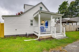 a white house with a porch and a fence at Walk to Beach Hampton Home with Grill! in Hampton