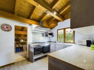 a kitchen with wooden ceilings and a stove top oven at Chalet Montvalezan-La Rosière, 9 pièces, 14 personnes - FR-1-398-647 in Montvalezan