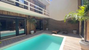 a swimming pool in the middle of a house at Harmonia Tulum in Tulum +7 photos