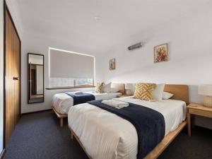 a hotel room with two beds and a mirror at Whale Watch Augusta Family Retreat in Augusta