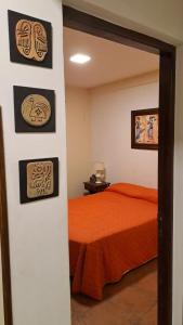 a bedroom with a bed and some pictures on the wall at LatorrePAS Dpto in Salta