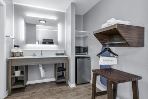 a bathroom with a sink and a vanity with a sink at Inn at Rockaway San Francisco Pacifica in Pacifica +40 photos