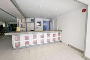 a kitchen with a counter with pink drawings on it at Apartamento Tenerife Sur in Playa de las Americas +14 photos