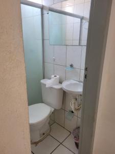 a bathroom with a toilet and a sink at Namoasuites in Maceió