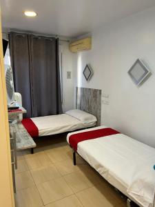 a room with two beds in a room at Hostal Las Vegas in Madrid